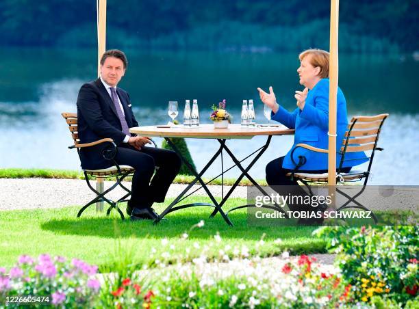 German Chancellor Angela Merkel and Italian Prime Minister Giuseppe Conte talk during a meeting on July 13, 2020 in the garden of the German...