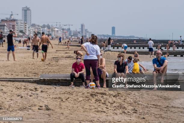 Bathers speak by the sea in Jesolo beach, reopened from today the beaches in Veneto on May 23, 2020 in Venice, Italy. Restaurants, bars, cafes,...