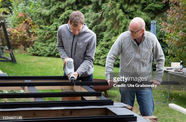 In this photo illustration two men building a substructure for a terrace A metal substructure for a wooden deck on October 27, 2018 in Bonn, Germany.