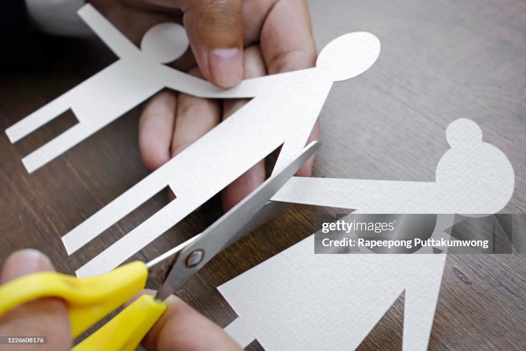 Scissors cutting paper family. Divorce effect concept.