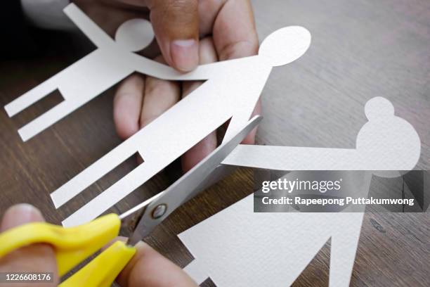 scissors cutting paper family. divorce effect concept. - marriage separation stock pictures, royalty-free photos & images