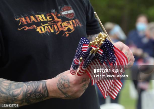 Volunteers place flags at the Calverton National Cemetery on May 23, 2020 in Wading River, New York. The U.S. Department of Veterans Affairs...