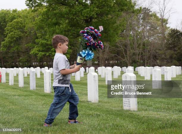 The Sperandio family of Farmingdale visits the grandfathers grave at Calverton National Cemetery on May 23, 2020 in Wading River, New York. Health...