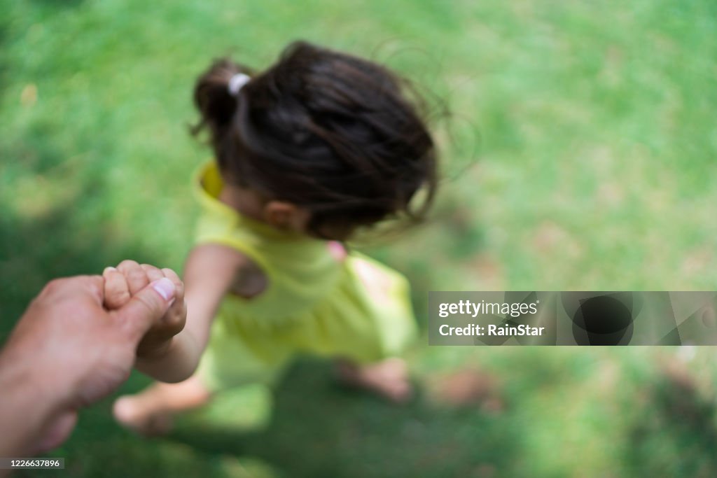 Mother and child holding hands
