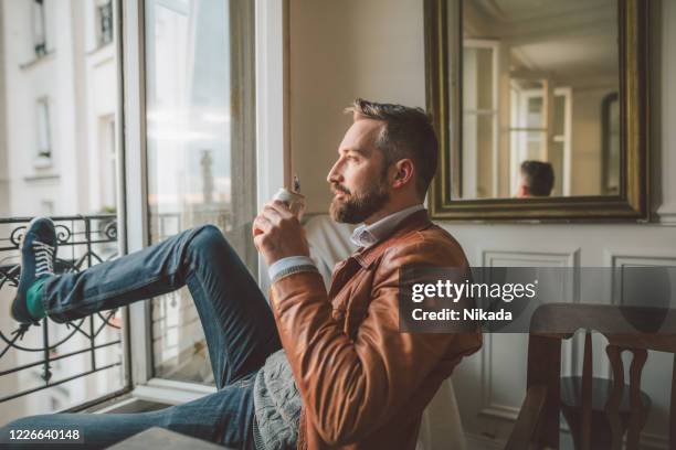 man with beer can looking out over the city at sunrise - listening tin can stock pictures, royalty-free photos & images