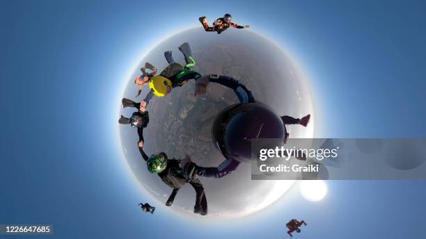group of skydivers together with a special image - 360 globe stockfoto's en -beelden