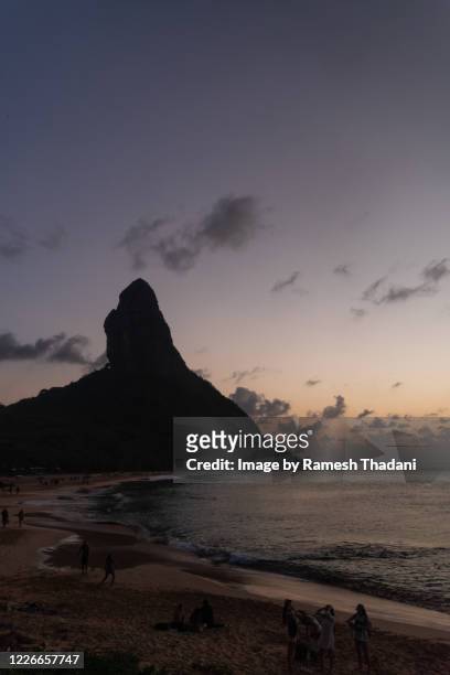 sunset on the conceicao beach - beach goers stock pictures, royalty-free photos & images