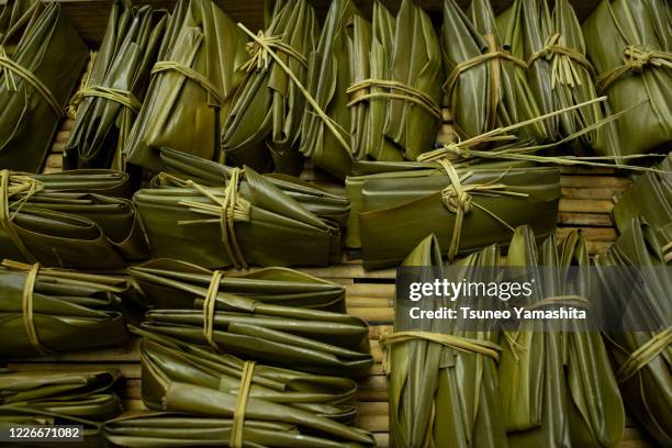 okinawan rice cake wrapped with a leaf of shell ginger - alpinia zerumbet stock pictures, royalty-free photos & images
