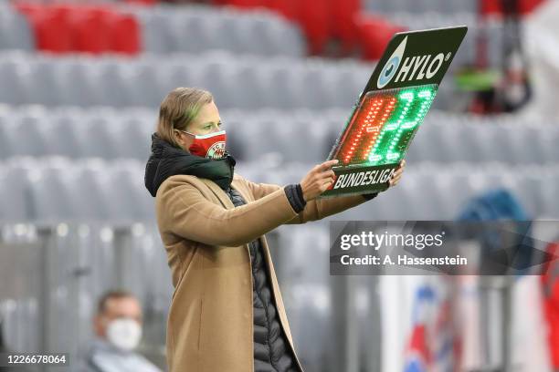 Kathleen Krüger, team managerin FC Bayern Muenchen holds the substitution board during the Bundesliga match between FC Bayern Muenchen and Eintracht...