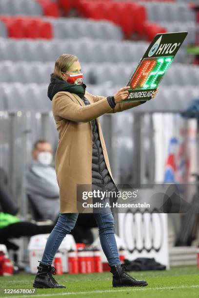 Kathleen Krüger, team managerin FC Bayern Muenchen holds the substitution board during the Bundesliga match between FC Bayern Muenchen and Eintracht...