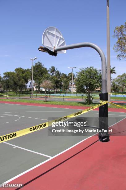 caution tape around outdoor basketball court - sign ban stock pictures, royalty-free photos & images