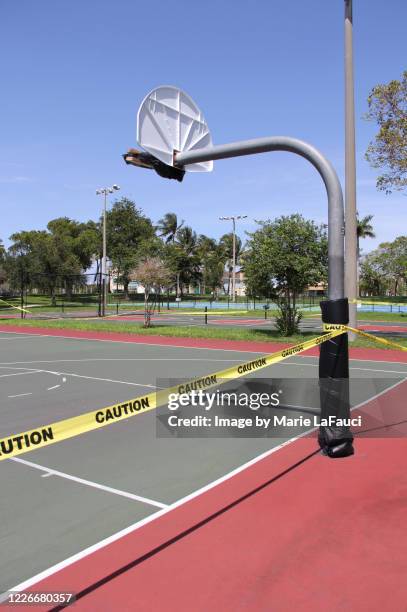 caution tape around outdoor basketball court - out of bounds sport stock pictures, royalty-free photos & images