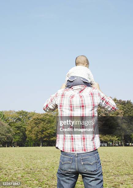 father carrying baby on his shoulders - buttock photos stock pictures, royalty-free photos & images