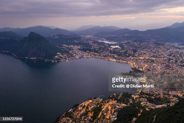 aerial view of the lugano city from the monte bré by lake lugano in canton ticino in switzerland - lugano stock-fotos und bilder