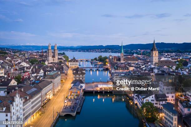 twilight over zurich old town along the limmat river  in switzerland largest city - zurich switzerland stock pictures, royalty-free photos & images