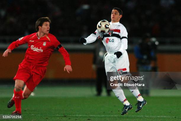 Cicinho of Sao Paulo and Xabi Alonso of Liverpool compete for the ball during the FIFA Club World Championship Toyota Cup final between Sao Paulo and...