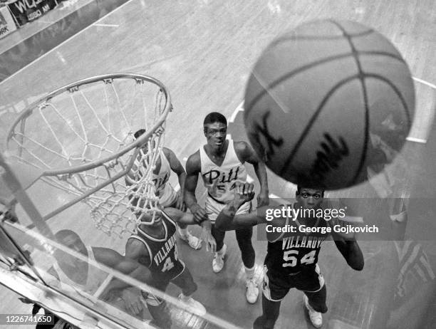 Forward Ed Pinckney and guard Frank Dobbs of the Villanova University Wildcats and center Keith Armstrong of the University of Pittsburgh Panthers...