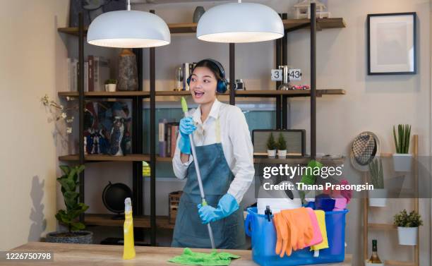 dancing and singing woman wiping floors at a new apartment - wet carpet stock pictures, royalty-free photos & images