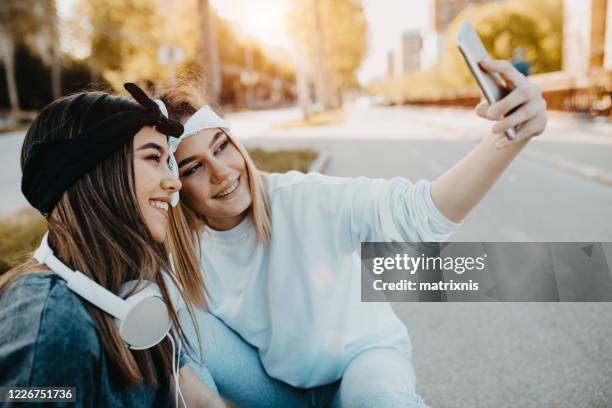 hey sister let us make one selfie - hey pretty girl stock pictures, royalty-free photos & images