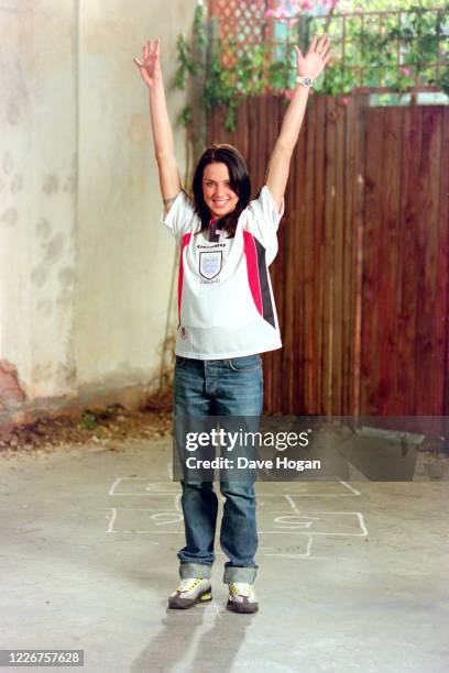 Melanie Chisholm of The Spice Girls wearing an England shirt to record the video for the single " On Top of the World", England's official song for...