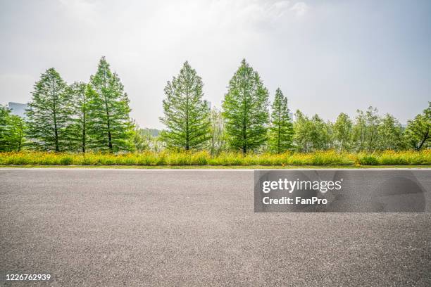 empty road and park - empty road stock pictures, royalty-free photos & images