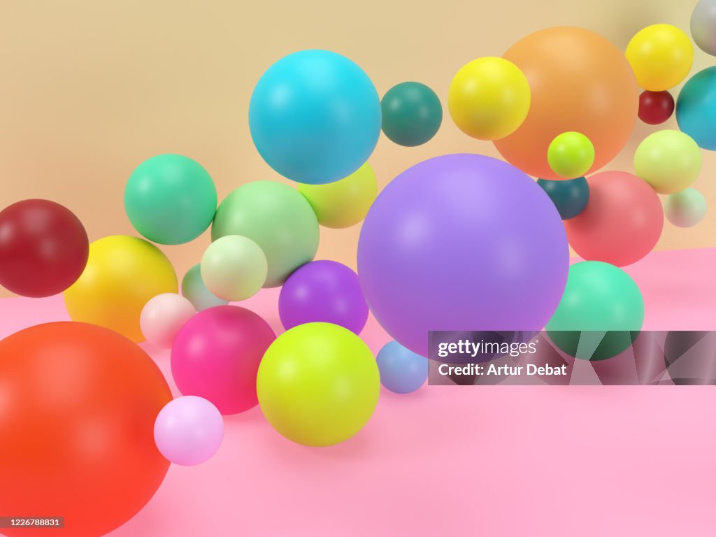 Creative digital picture of colorful balls levitating in studio set.