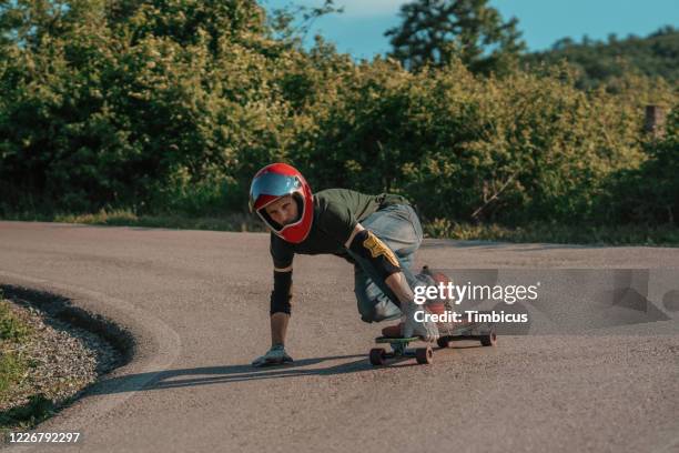 longboard rider riding downhill - longboard surfing stock pictures, royalty-free photos & images