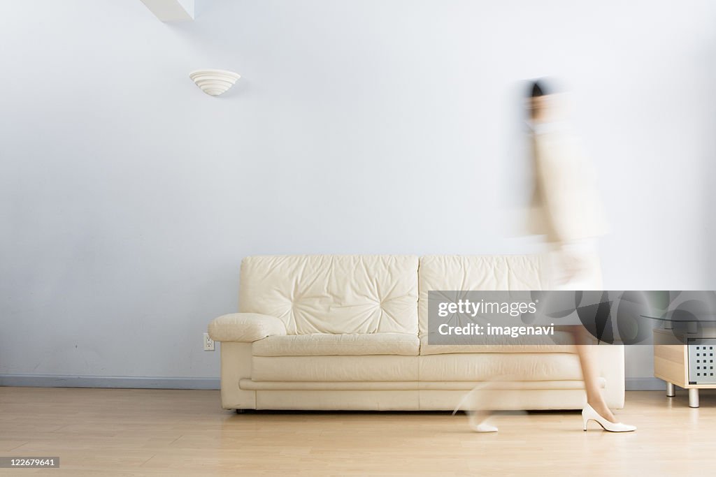 Woman Crossing Living Room