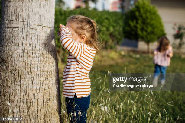 children playing hide and seek - hidw and seek stock pictures, royalty-free photos & images