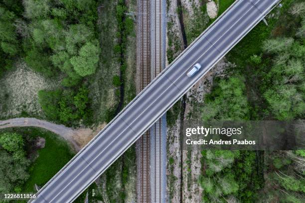 aerial top-down view of a highway overpassing a railway - estonia stock pictures, royalty-free photos & images