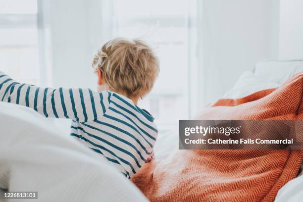 boy getting out of bed - bolster stock pictures, royalty-free photos & images