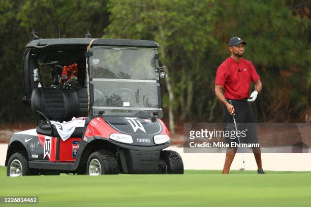 Tiger Woods prepares to play a shot on the first hole during The Match: Champions For Charity at Medalist Golf Club on May 24, 2020 in Hobe Sound,...