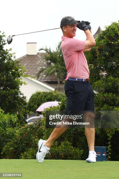 Former NFL player Peyton Manning plays his shot from the third tee during The Match: Champions For Charity at Medalist Golf Club on May 24, 2020 in...