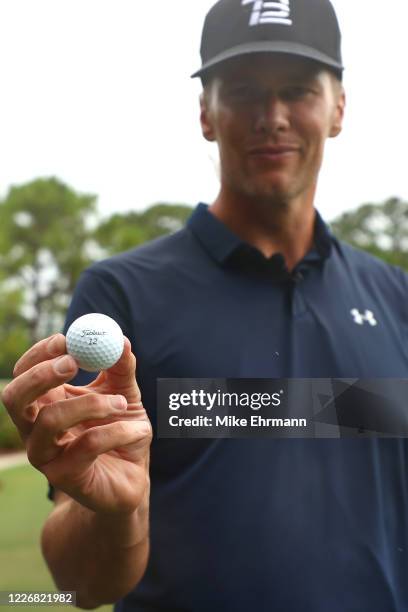 Player Tom Brady of the Tampa Bay Buccaneers displays his ball during The Match: Champions For Charity at Medalist Golf Club on May 24, 2020 in Hobe...