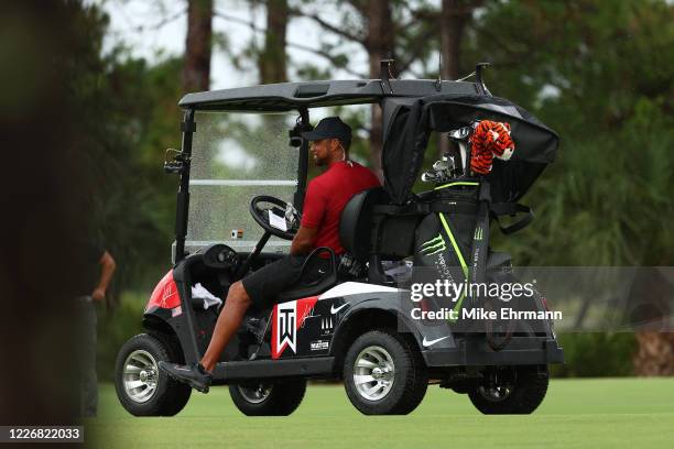 Tiger Woods look son from his cart on the fifth hole during The Match: Champions For Charity at Medalist Golf Club on May 24, 2020 in Hobe Sound,...