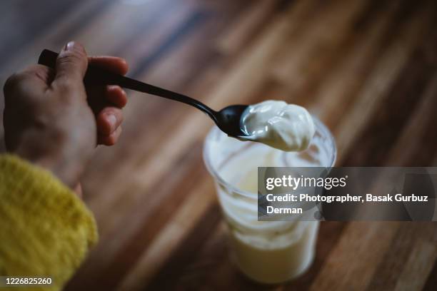 eating yogurt - yogurt container stock pictures, royalty-free photos & images