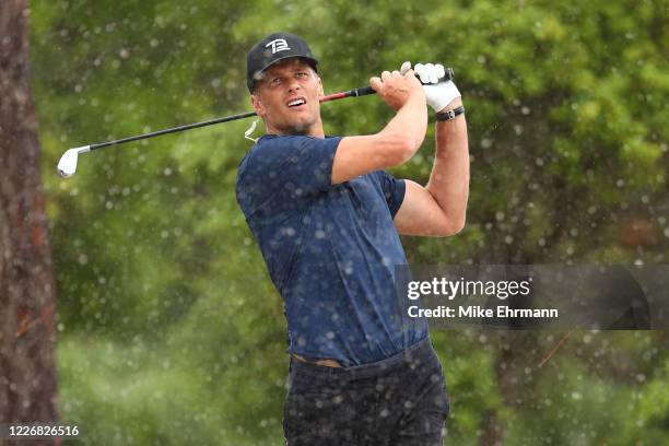 Player Tom Brady of the Tampa Bay Buccaneers plays a shot from the sand on the seventh hole during The Match: Champions For Charity at Medalist Golf...