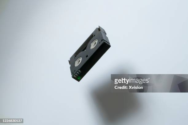 videotape flying in mid air with white background sync in high speed - movie still stock-fotos und bilder