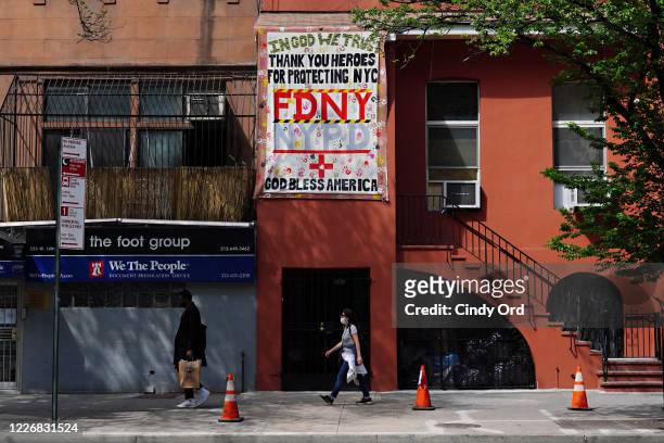 Sign outside a residential building thanks FDNY and NYPD during the coronavirus pandemic on May 24, 2020 in New York City. COVID-19 has spread to...