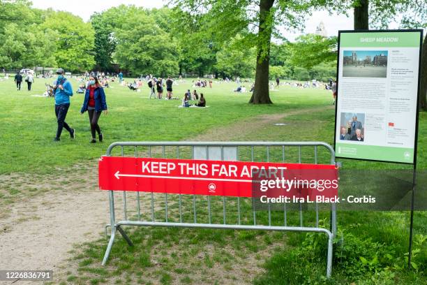 On Memorial Day weekend a sign at the entrance of Sheep Meadow in Central Park says "Keep this Far Apart" physically showing how far 6 feet is with...