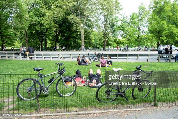 On Memorial Day weekend bicycles lean up against a fence while the riders take in some rest with others in Central Park. On May 24, New York State...