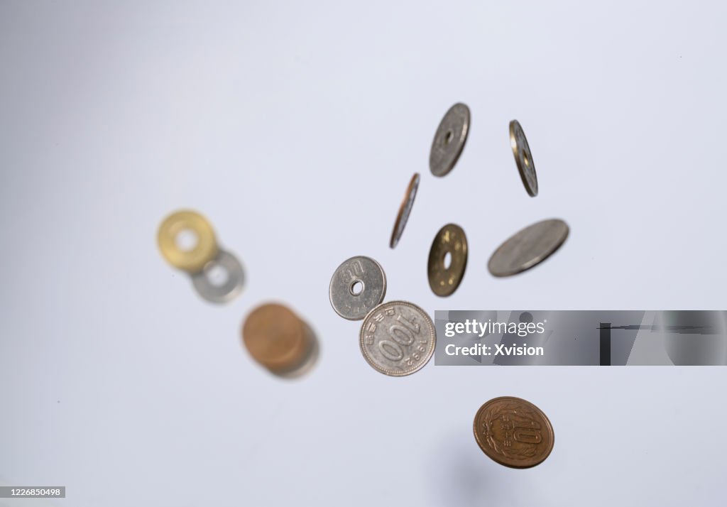 Japanese coin money flying in mid air with white background sync in high speed