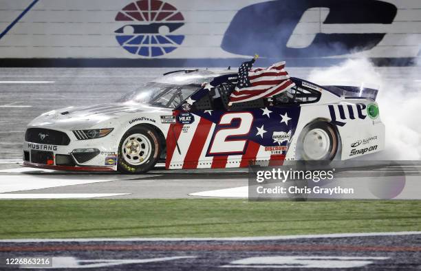 Brad Keselowski, driver of the Miller Lite Ford, celebrates after winning the NASCAR Cup Series Coca-Cola 600 at Charlotte Motor Speedway on May 24,...