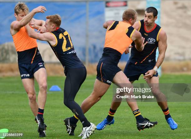 Rory Sloane of the Crows takes on Tom Lynch of the Crows as Daniel Tahlia of the Crows takes on Taylor Walker of the Crows during an Adelaide Crows...