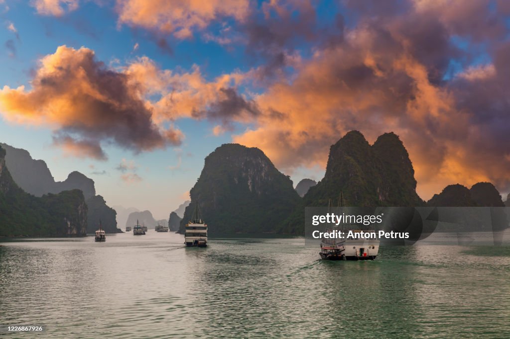 Sunset in Halong Bay, Vietnam. View of cruise ships and islands in Halong Bay, Vietnam