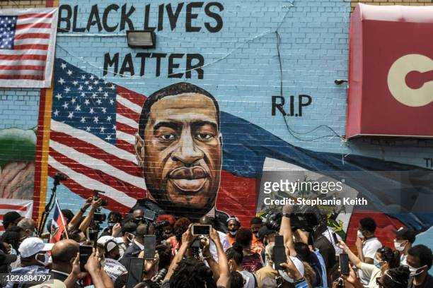 Mural painted by artist Kenny Altidor depicting George Floyd is unveiled on a sidewall of CTown Supermarket on July 13, 2020 in the Brooklyn borough...