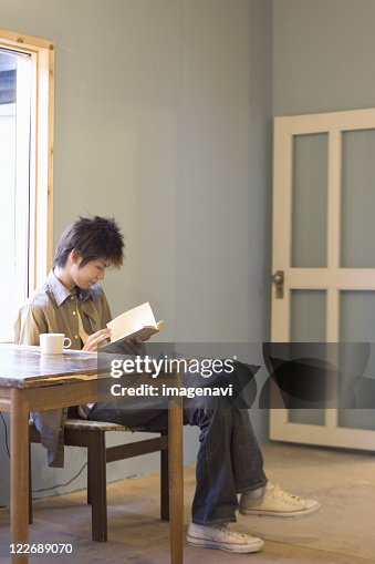 Young man reading book Young man reading book