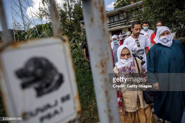 Bosnian Muslim woman, relatives of victims of Srebrenica genocide, visit one of the sites of 1995 mass execution of their loved ones, on July 13,...