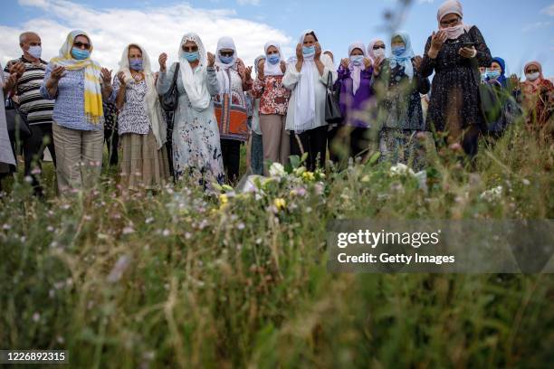 Bosnian Muslim women pray as relatives of victims of Srebrenica genocide visit sites of 1995 mass execution of their loved ones, on July 13, 2020 in...