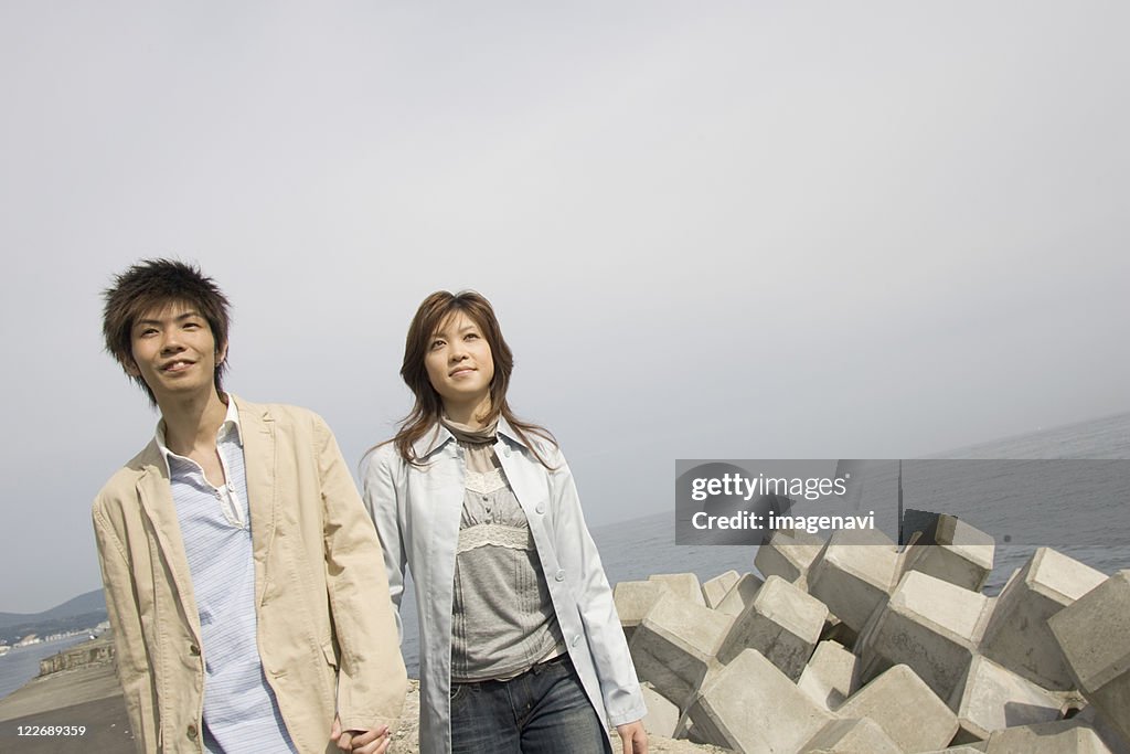 Couple walking along river bank